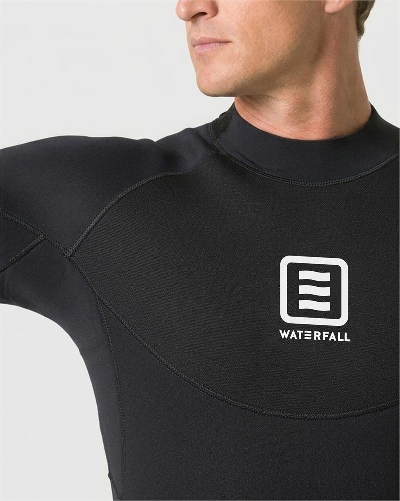 Black wetsuit chest with Waterfall emblem patch and stitched seam lines.