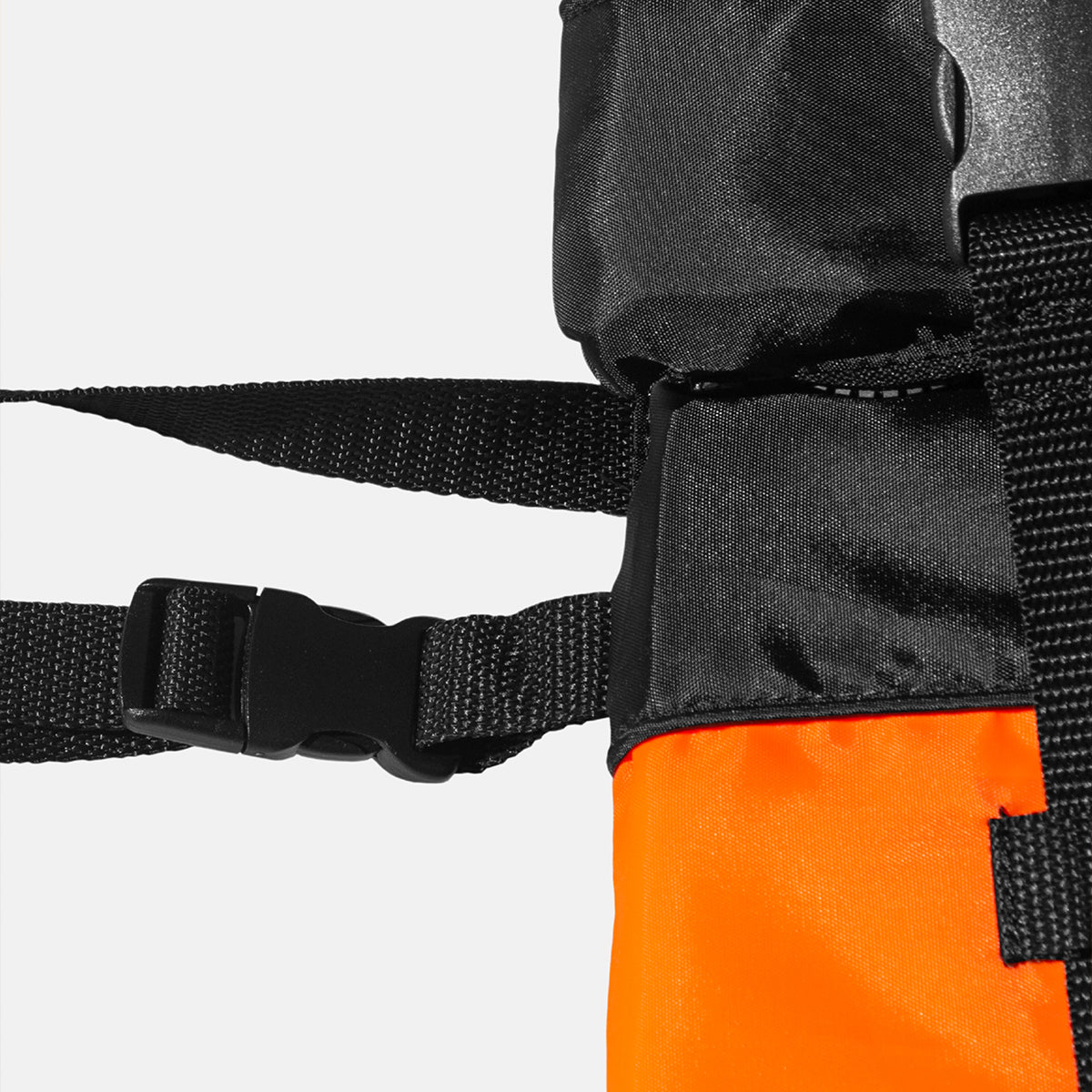 Kids buoyancy aid strap buckle detail on black webbing with orange bottom panel