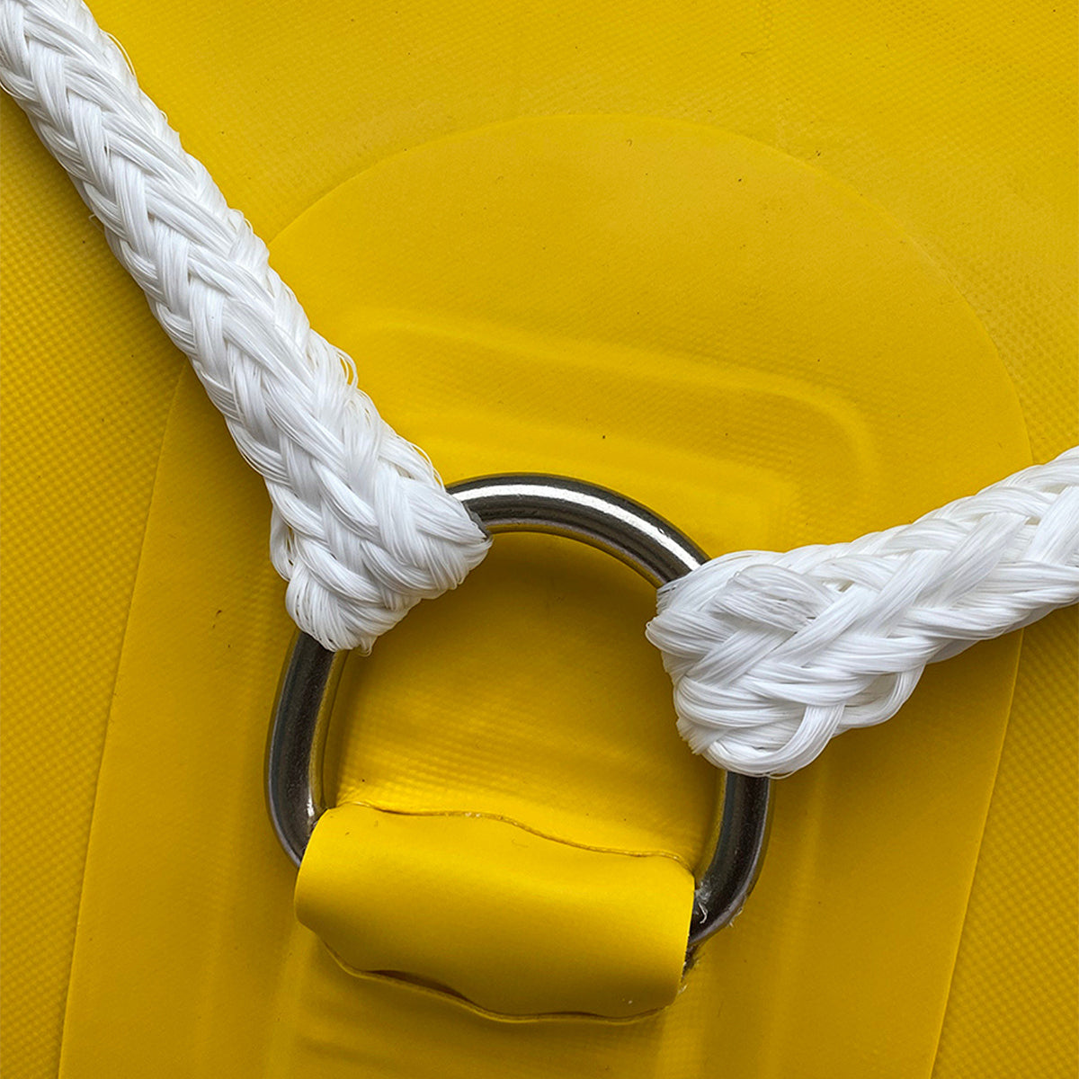 Yellow inflatable raft with white braided rope and metal D-ring attachment