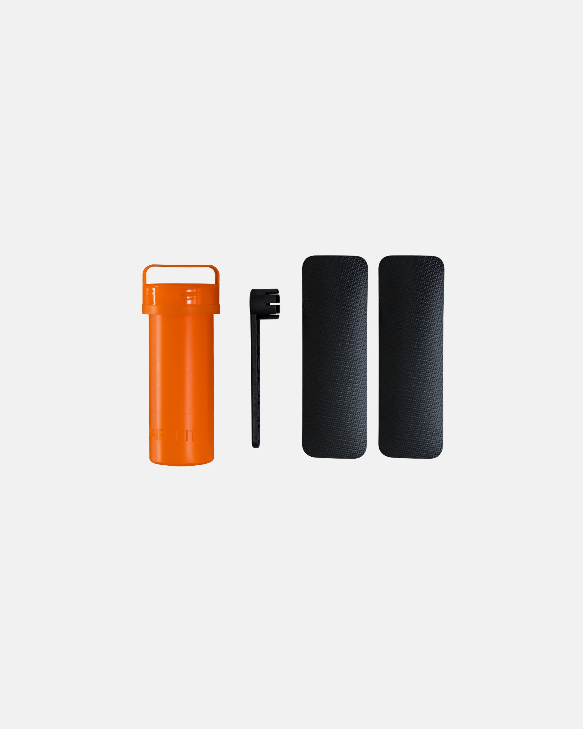 Inflatable SUP accessories set: orange bottle, black straps, and two traction pads