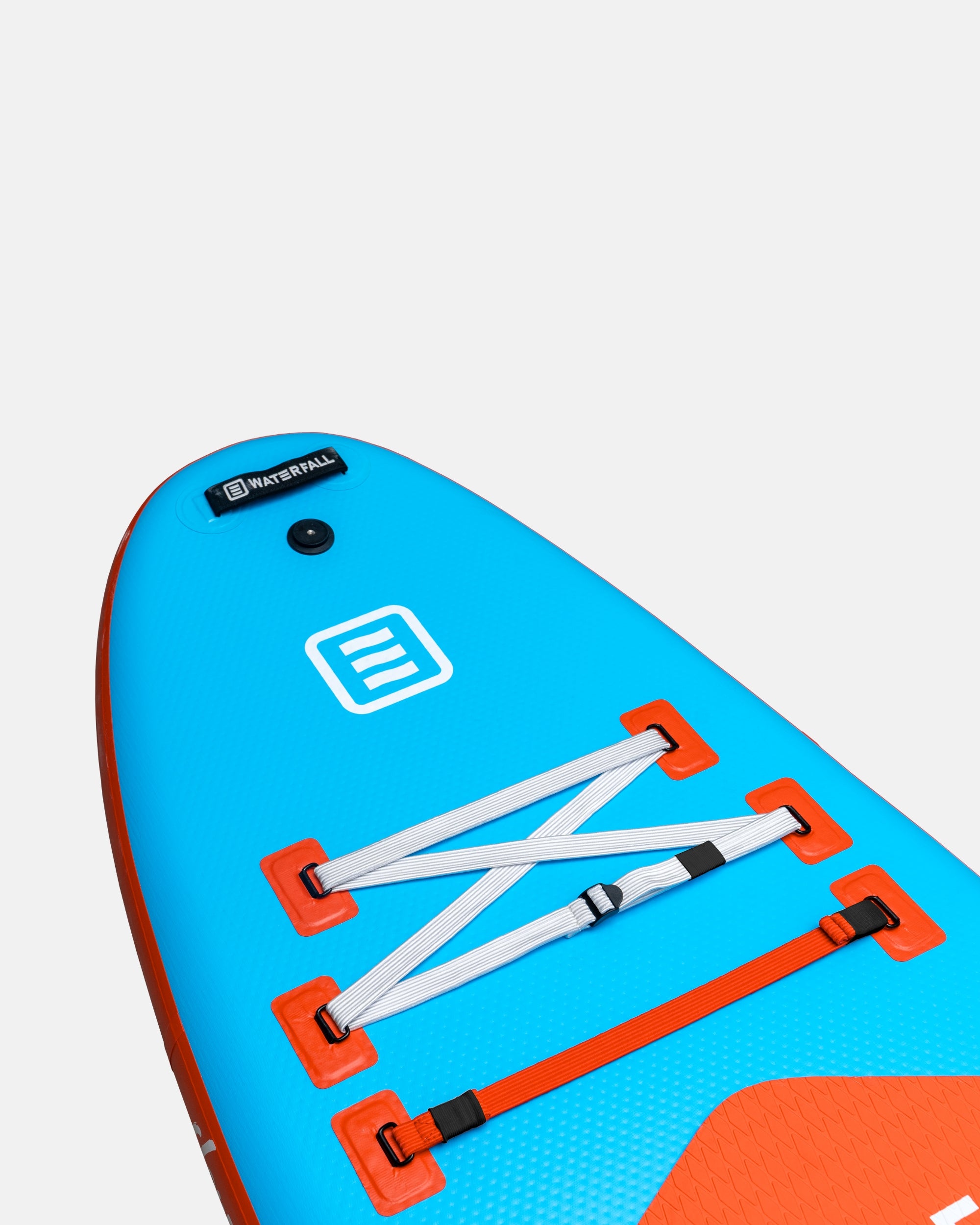 Inflatable blue SUP deck with orange section, bungee straps, and valve cover