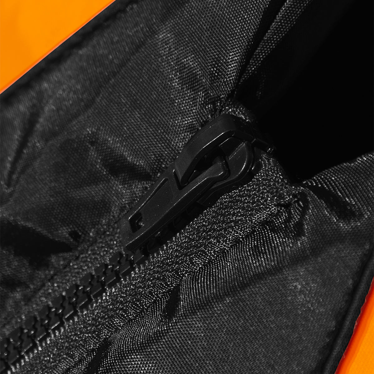 Kids buoyancy aid close-up: black zipper with orange trim
