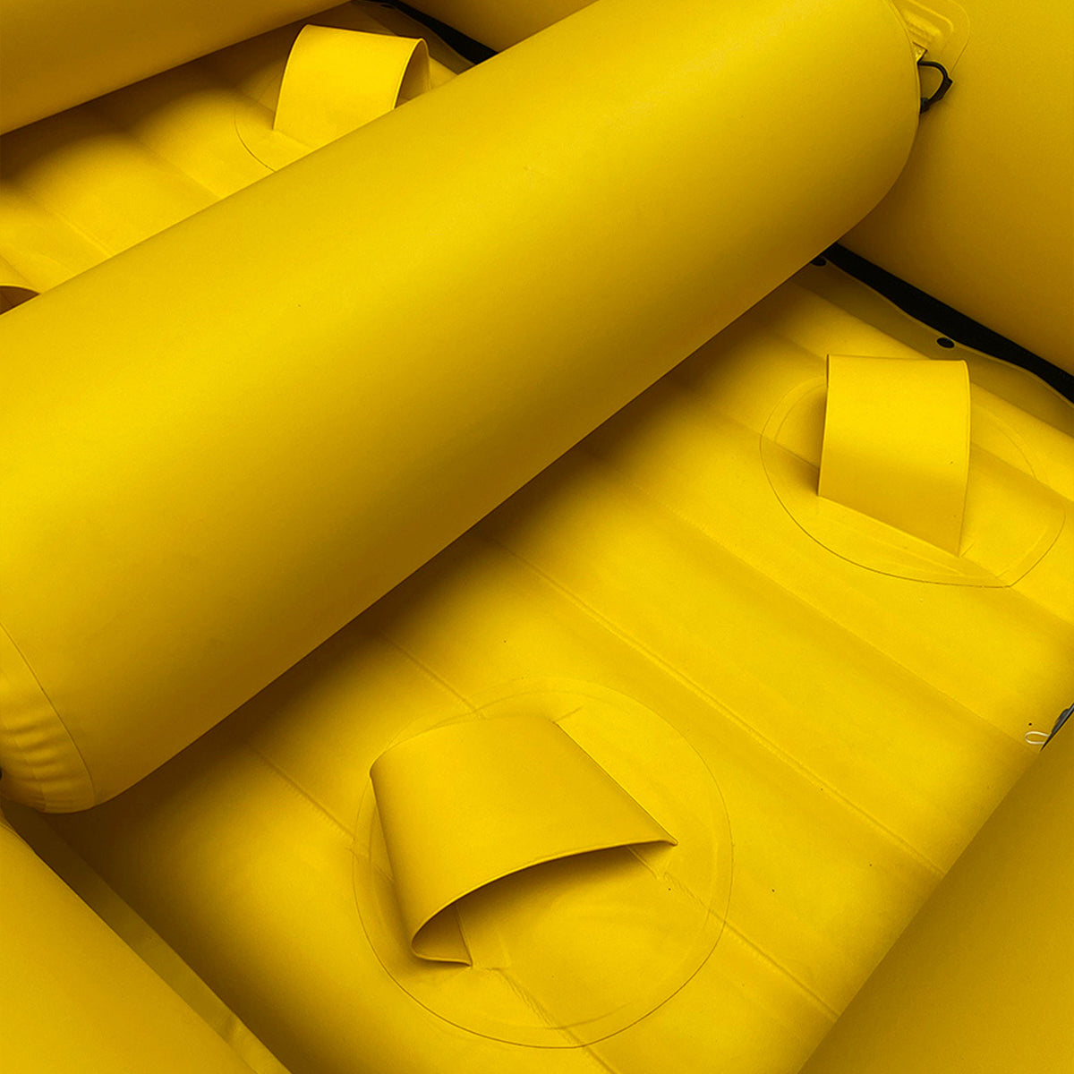 Yellow inflatable raft interior with padded floor and raised seat supports