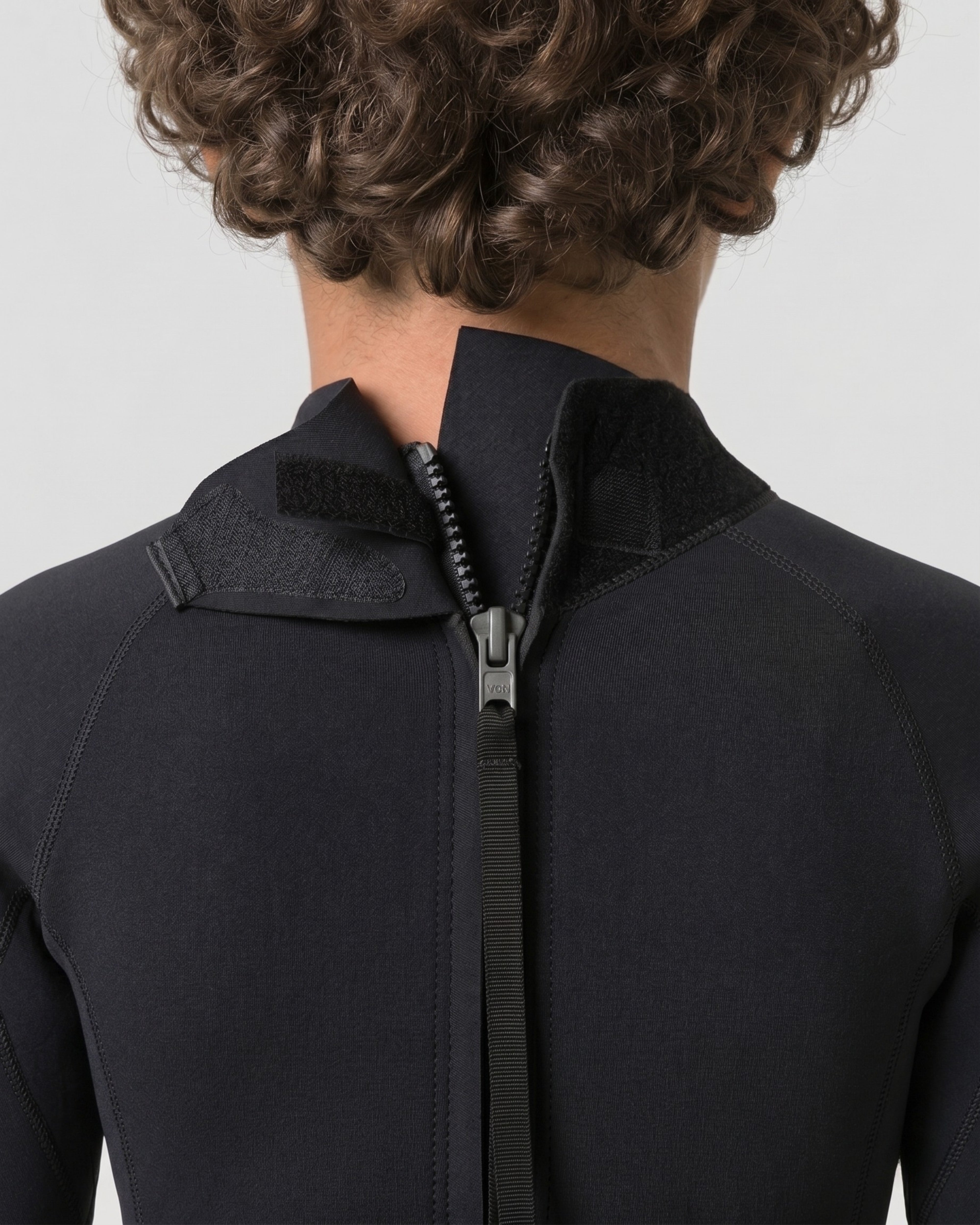 Kids wetsuit back collar close-up with visible back zipper and stitched panels